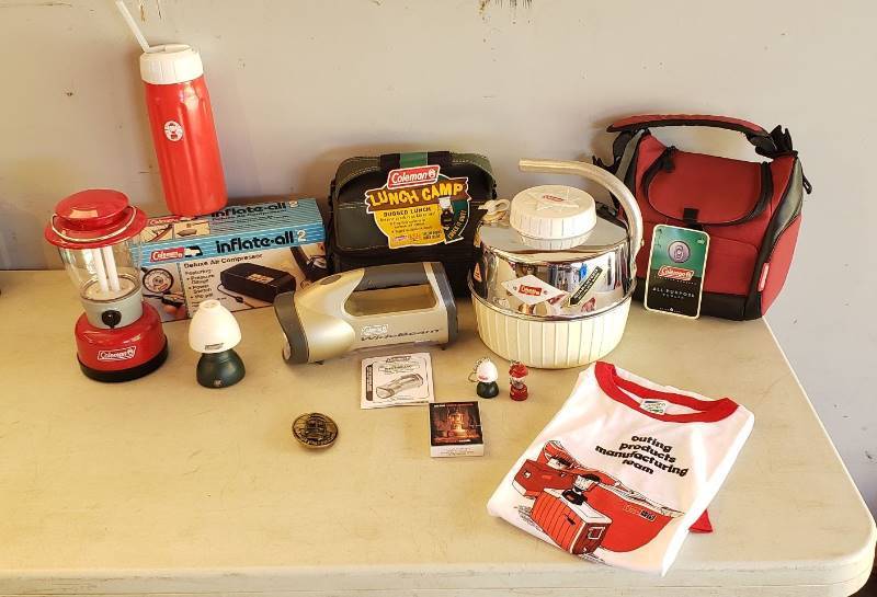 lot 2416 image: Lot of Coleman Products - Vintage Water Jug, Battery Powered Lantern, 1980s T-shirt, Brass Belt Buckle, (2) Lunch Coolers, Inflate-all 2, and Other Items