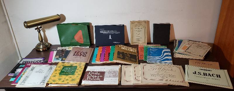 lot 2446 image: Lot of Organ Music Books and Brass Lamp (14 in. W x 18 in. T)