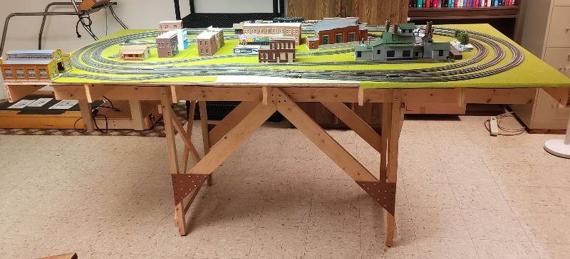 lot 2515 image: Massive HO train Layout with Numerous Structures and DCC compatible command control NCE Power Cab - 96 in. x 60 in. table top - legs must be removed to exit the basement