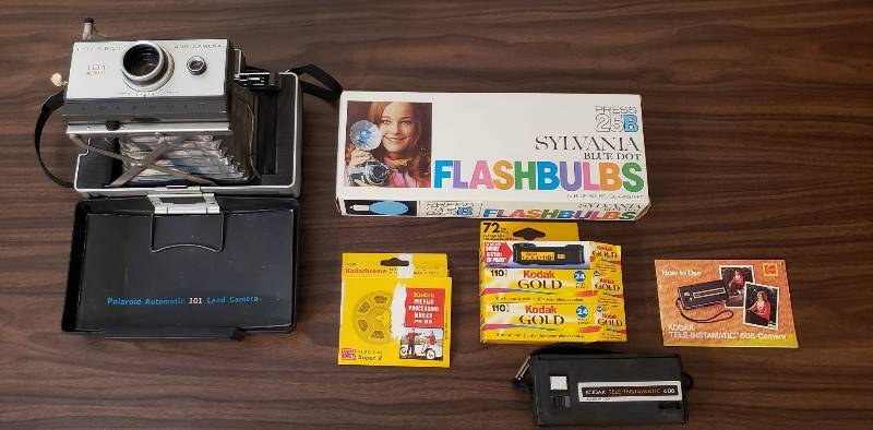 lot 2523 image: Lot of Vintage Polaroid Land Camera 101 Automatic, Kalart 400 BC Fkash Unit, Sylvania Flashbulbs, and Kodak 110 camera with film
