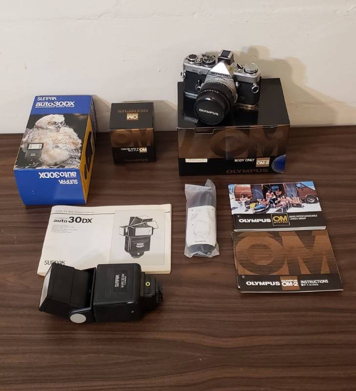 lot 2525 image: Vintage Olympus OM-2n 35MM Camera with 50 mm F1.4 Lens and Sunpak Auto 30DX Flash