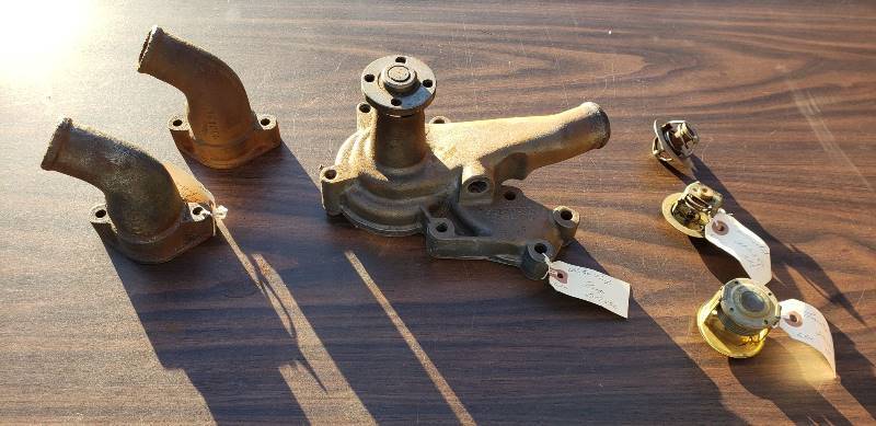 lot 2572 image: Kaiser 1950s Car Parts - Cooling System Parts - Radiators, Water Pump, and Thermostats