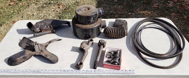 lot 2606 image: Kaiser 1950s Car Parts - Fan , Belts, Steering Gear and Air Intake Parts