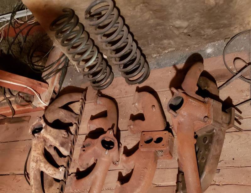 lot 2624 image: Kaiser 1950s Car Parts - 2 Spring Coils and 4 Headers - in Garage Attic