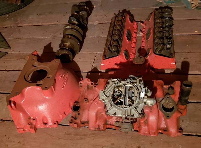 lot 2633 image: GM Motor Parts - Camshaft, Manifold, 4 barrel Carburetor, Water Pump, Valves, and Bell Housing - in Garage Attic