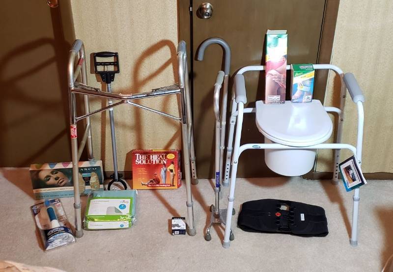 lot 2730 image: Lot of Medical Assistance Products - Commode, Walker, 2 Metal Canes, HeatCold Wraps, Grip Handle, Back Brace, and Underpad