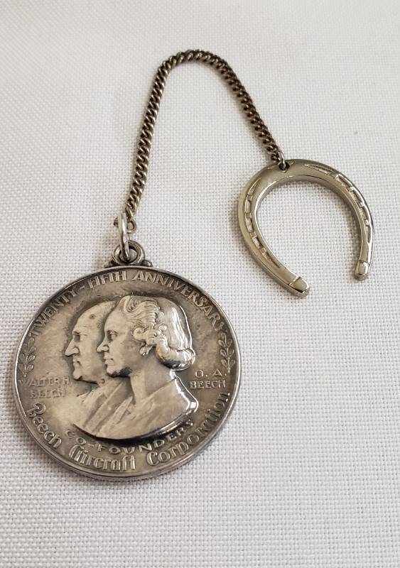 lot 2773 image: Beech Aircraft Corporation Twenty-Eight Anniversary (1932-1957) Sterling Lucky Medallion - 1 14 in. diameter