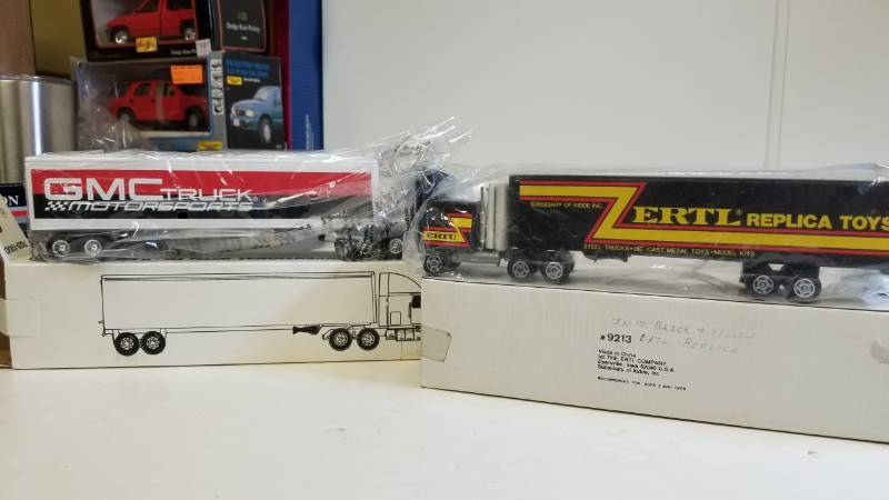 lot 3233 image: 2 ERTL Semi, both 164 scale, 1) GMC Truck Motorsports Semi  2) ERTL Replica Toys Semi, NIB