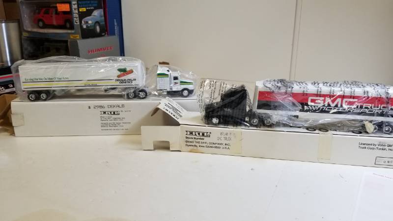 lot 3234 image: 2 ERTL Semi, both 164 scale, 1) GMC Truck Motorsports Semi  2) Dekalb (seed corn) Semi, NIB