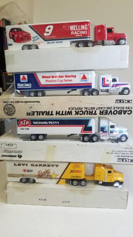 lot 3244 image: 4 Ertl Semi  STP Racinng  Melling Racing  Wood Brother Racing  Levi Garrett Racing, 164 scale, See pix, New Box