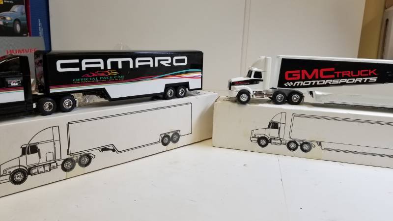 lot 3247 image: 2 ERTL Semi, both 164 scale, 1) GMC Truck Motorsports Semi  2) CAMARO Semi, NIB