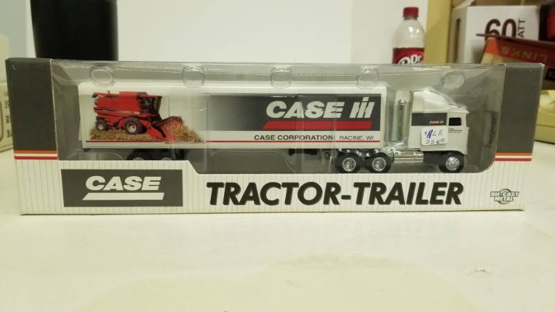 lot 1194 image: Case IH tractor trailer with combine pic on trailer