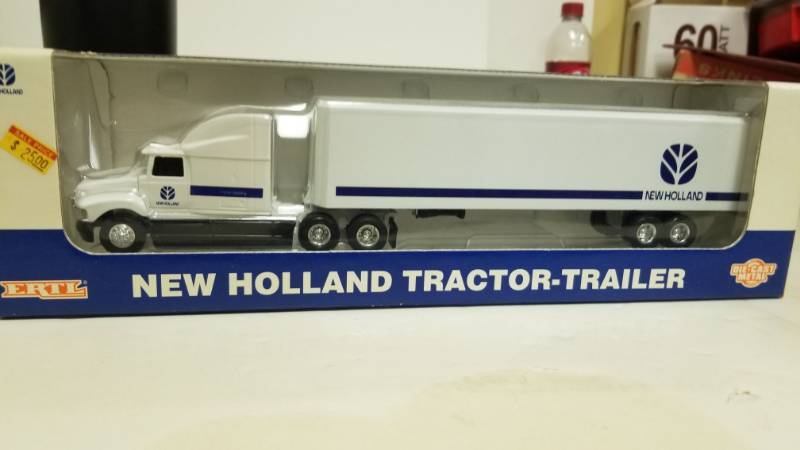 lot 1209 image: 164 Holland Tractor & Trailer Set With Display Box Ertl Diecast Metal Semi