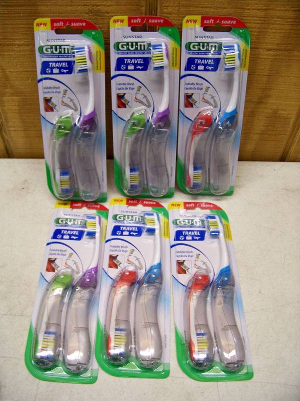 lot 493 image: 12 Gum Travel Toothbrushes