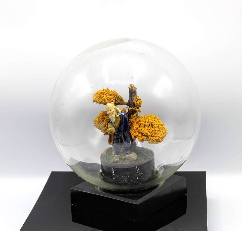 lot 1107 image: Asian Man Beside Bonsai Tree in Glass Globe