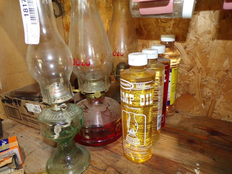 lot 1817 image: 3 Oil Lamps and 4 Bottles Lamp Oil - 2 Lamps have Coors Chimneys