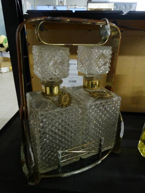 lot 1480 image: Vintage Scotch & Vodka Decanter set w brass holder