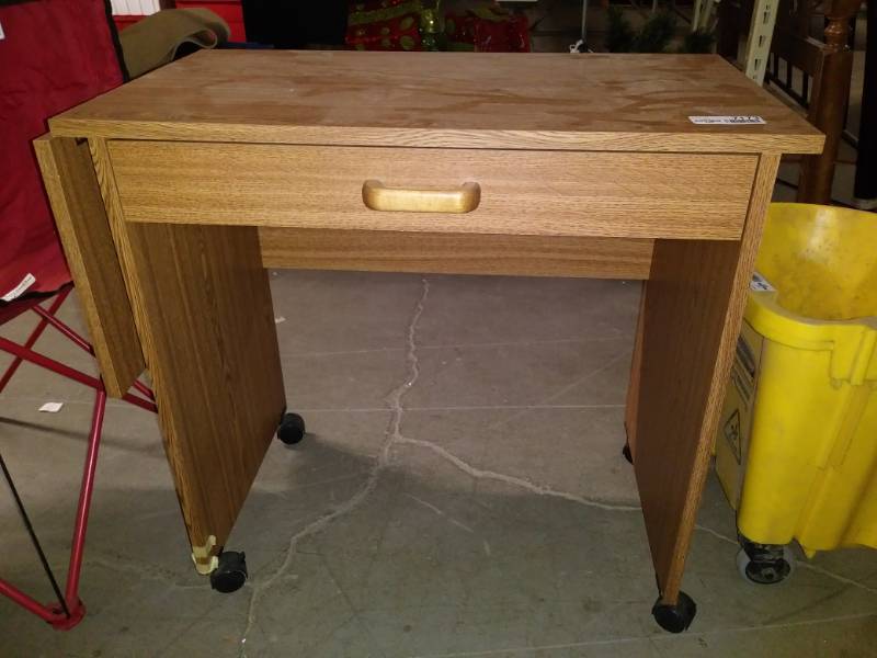 lot 7173 image: Small desk has fold down side and is on wheels.