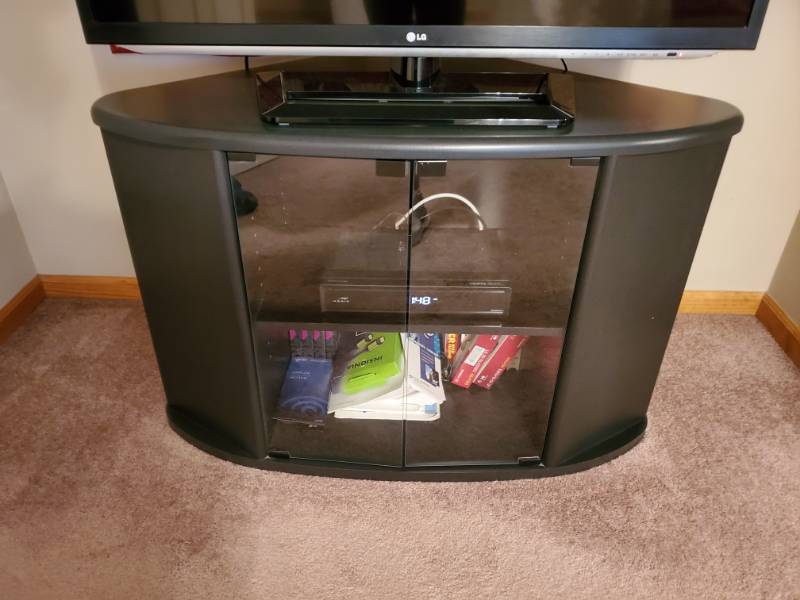 lot 138 image: Black Oval Double Shelf Glass Door TV Stand