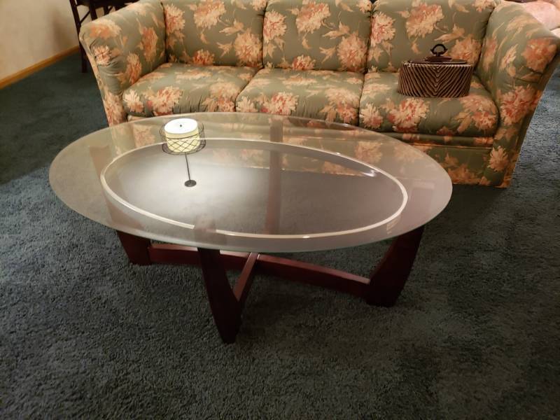 lot 7418 image: Wood based coffee table with glass top.