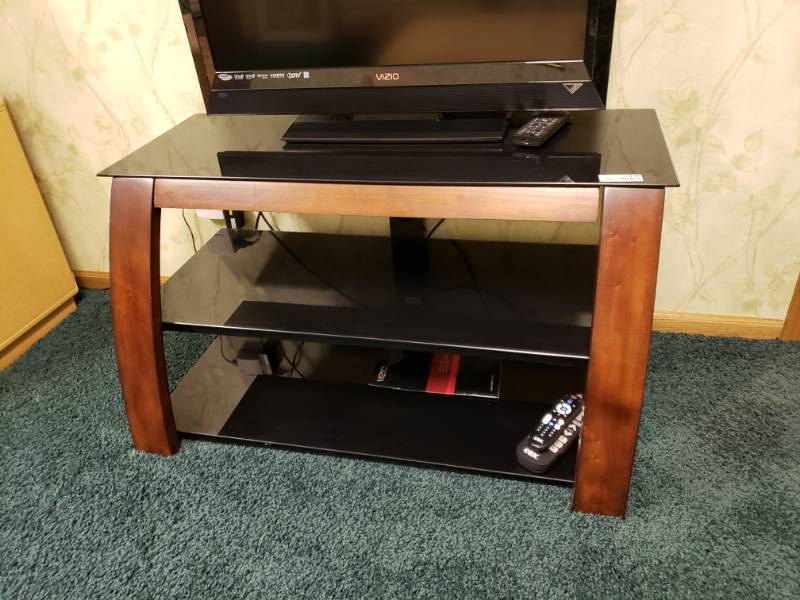 lot 7446 image: Nice wooden based, glass shelf tv stand.