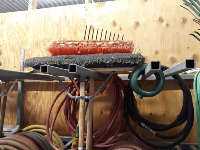 lot 5381 image: Assorted Brooms, Rake, Hoses.