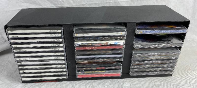 lot 3434 image: Lot of music CDs in a storage case - see pics for titles