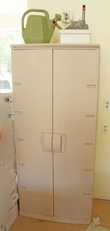 lot 1570 image: Neat Garage Storage Cabinet - Perfect for lawn and garden stuff