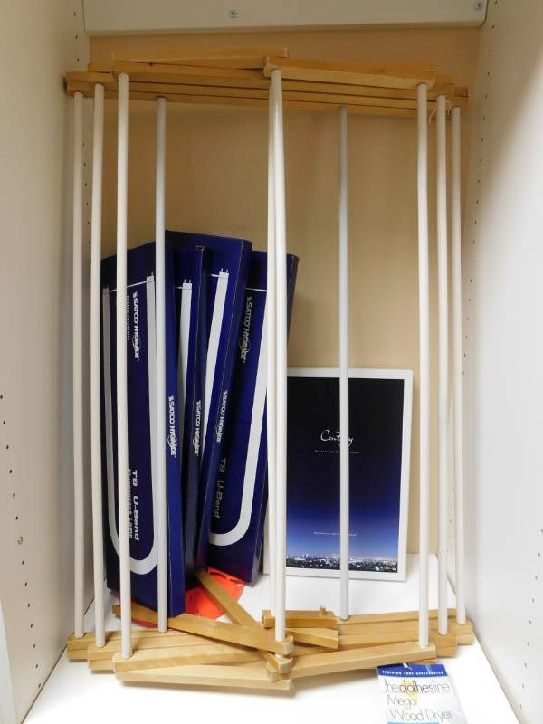 lot 3422 image: Folding Wood Clothes Line, 4 Boxes of Satco Highgrade Flourescent Lamp U-Bend Bulbs