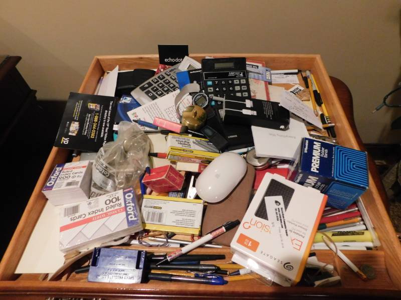 lot 3496 image: Spool of Forever Stamps, Calculator, Mac Wireless Mouse, Mini-Tape Cassette Recorder, and Various Office Supplies