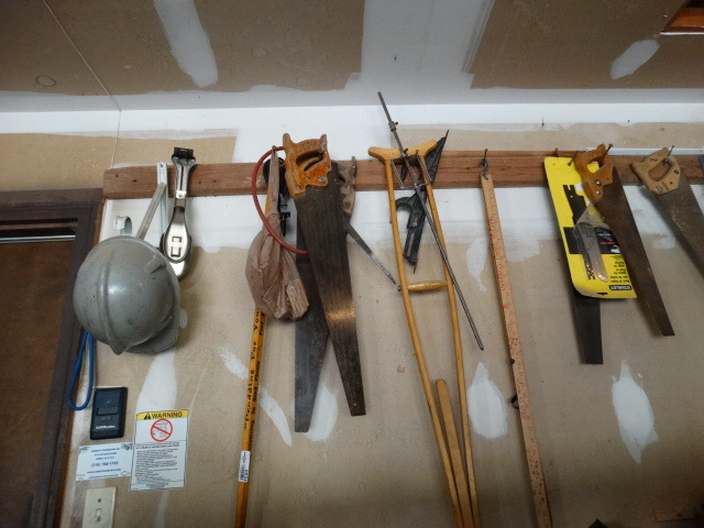 lot 6034 image: Saws tools misc on wall