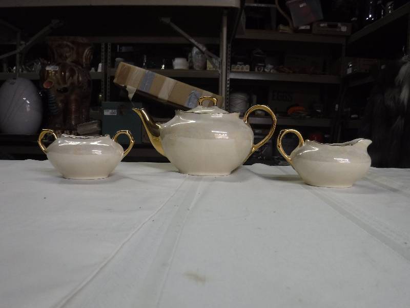 lot 8143 image: Pearl China Co 22 K gold hand decorated made in the USA tea set with cream and sugar