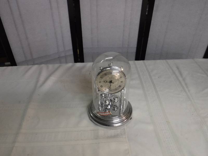 lot 8255 image: Bulova quarts clock in glass dome