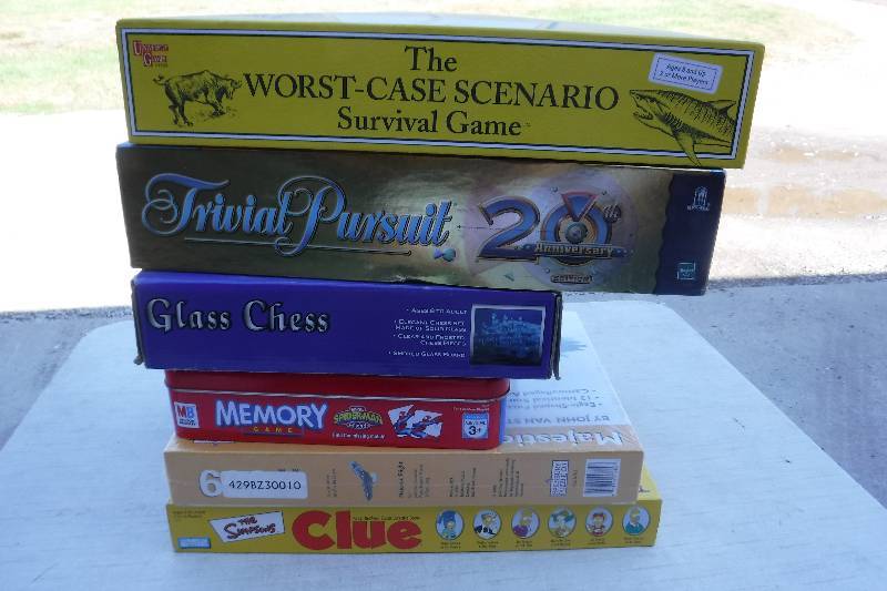 lot 7422 image: Board game lot- includes simpsons clue and worst case survival