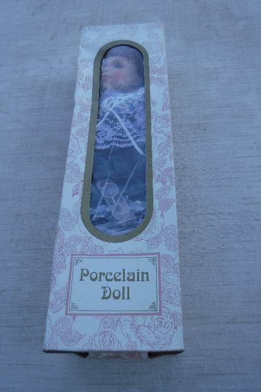 lot 7439 image: Porcelain doll with glasses