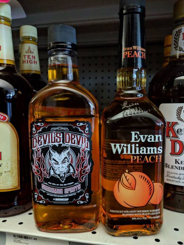 lot 8795 image: (2) Bittles Of Flavored Liquor, One Evan Williams Kentucky Straight Bourbon Whiskey Blended Peach 750mL, Devils Devil Sinnamon Spririts