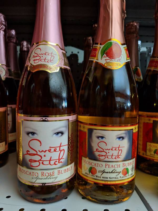 lot 9256 image: (2) 750mL Sweet Bitch Moscato Bottles, One Is Moscato Peach Bubbly 5.5 Perc Alc By Vol, Moscato Rose Bubbly Sparkling Wine 7 Perc Alc By Vol