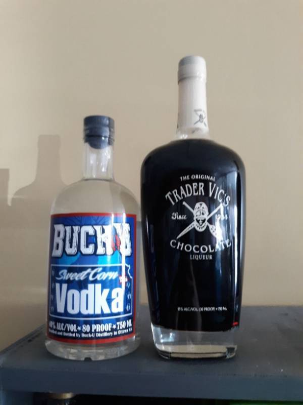 lot 9825 image: (3) (1) Buck U Vodka (2) Trader Vics Choc Liqueur