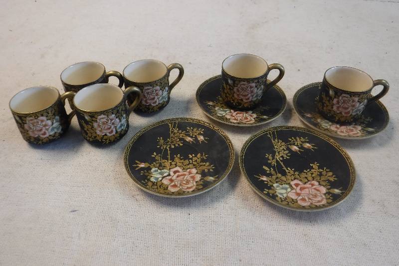 lot 12261 image: Black and floral tea cups and plates with oriental symbols on the bottom- very pretty