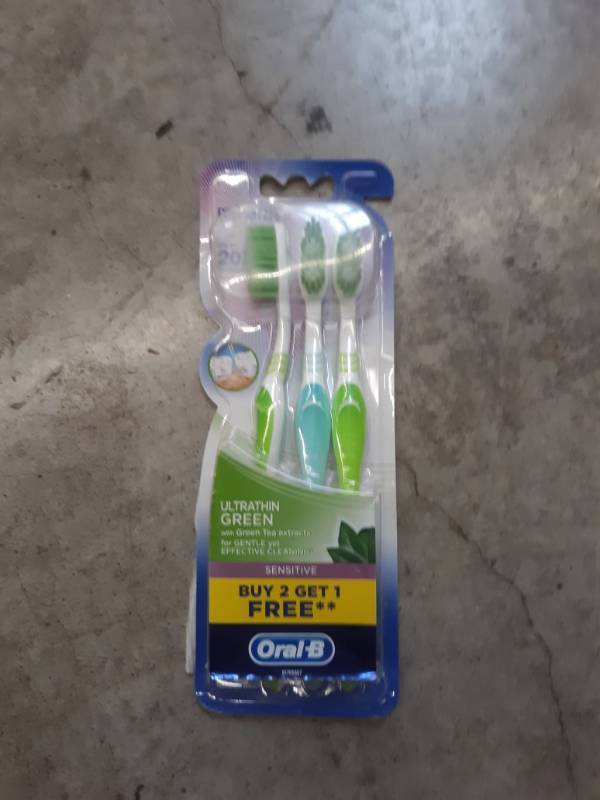 lot 14586 image: Oral-B ultra thin green extra soft toothbrush