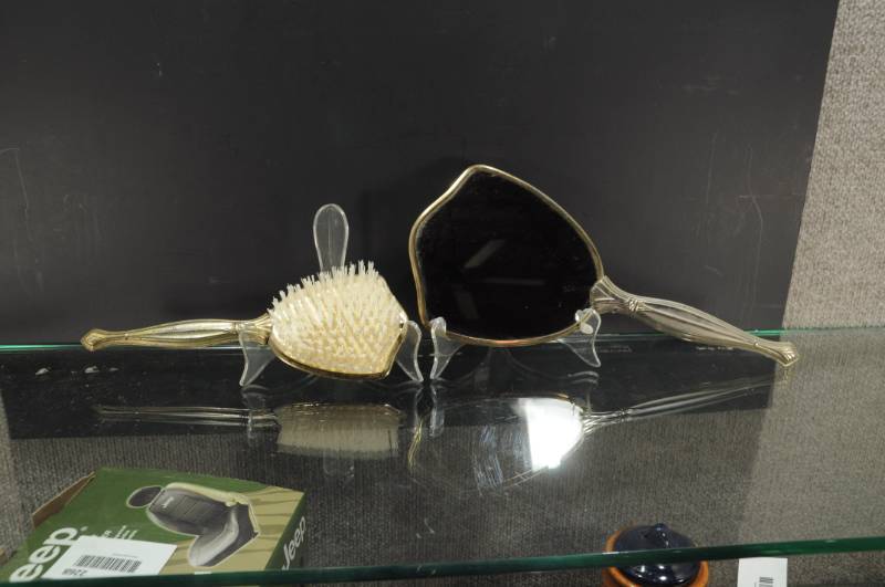 lot 2267 image: Lot 2 Vanity Set Mirror and Brush. Pressed Metal engraved back 13.5 Mirror 10 Brush.