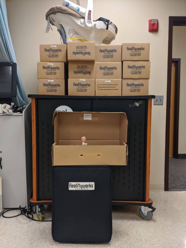 lot 3880 image: (13) Realityworks Real Care Baby Manikins And Locking Storage Cabinet