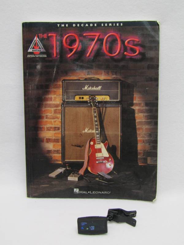 lot 5585 image: Guitar Music Book- 70s Classics and Bonus Electronic Guitar Tuner