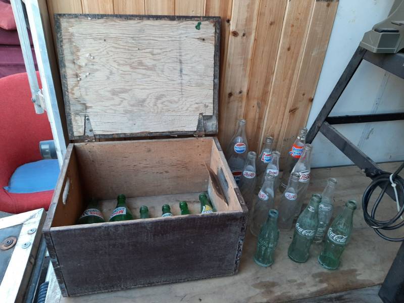 lot 1314 image: Wood crate with assorted glass pop bottles