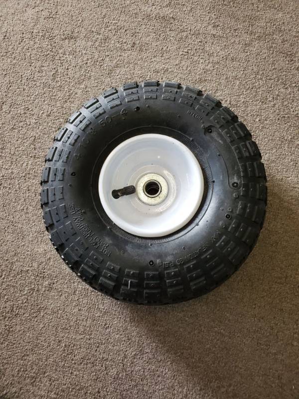 lot 16254 image: DOLLYGARDEN CARTWHEEL BARREL WAGON Tire and wheel.