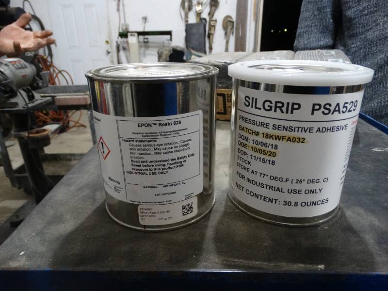 lot 4164 image: Can of Epon resin 828 & can of Silgrip pressure sensitive adhesive