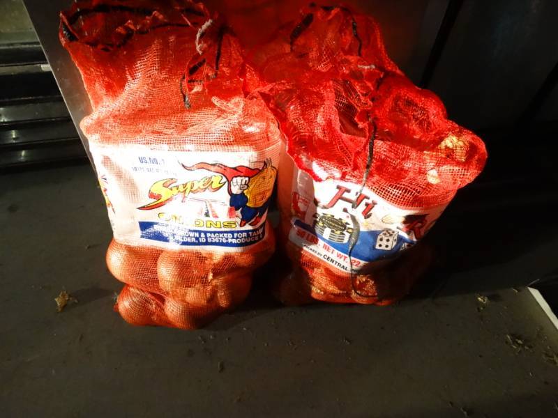 lot 4917 image: 2 partial bags of onions