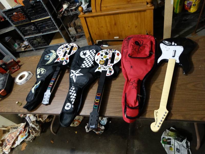 lot 2055 image: Lot of 3 Guitar Hero Guitars with Carrying case