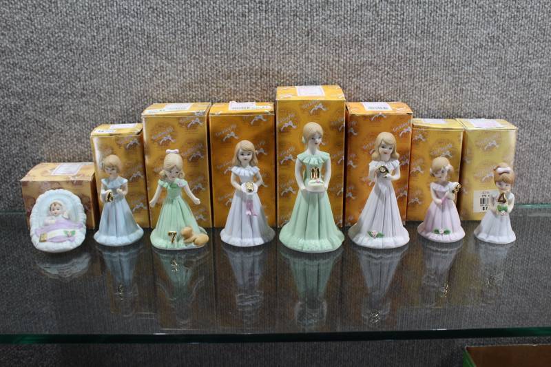 lot 2407 image: Lot of 8 Enesco Growing Up Birthday Girl Figures in Boxes 1980s