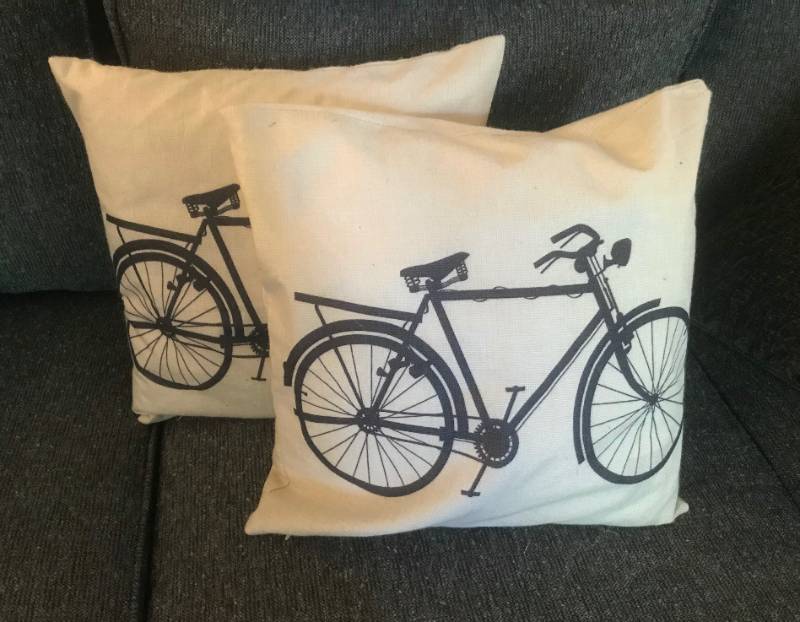 lot 1095 image: Set of two throw pillows with bicycle print